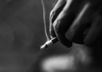 Close-up of hands smoking cigarette