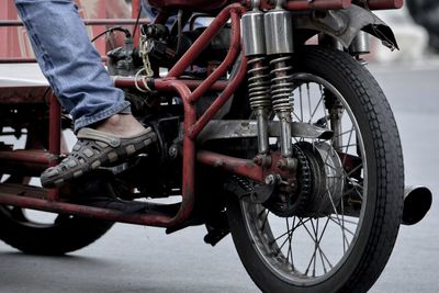 Low section of man working on motorcycle