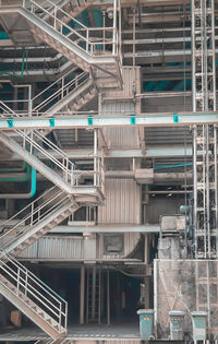 Low angle view of industry against buildings in city