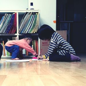 Children playing on hardwood floor at home