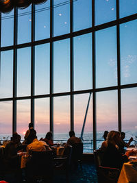 People in restaurant cruise ship during sunset