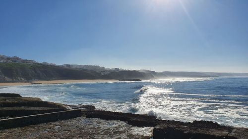 Scenic view of sea against sky on sunny day