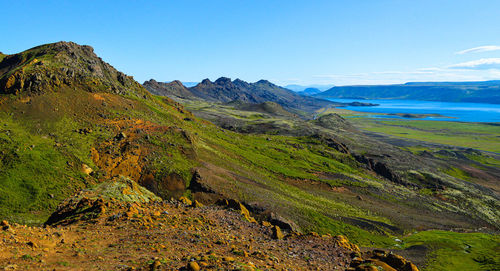 Scenic view of landscape and mountains against clear blue sky