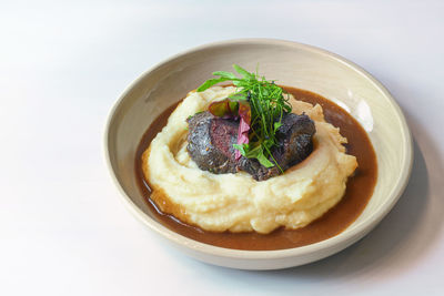 High angle view of food in bowl on white background