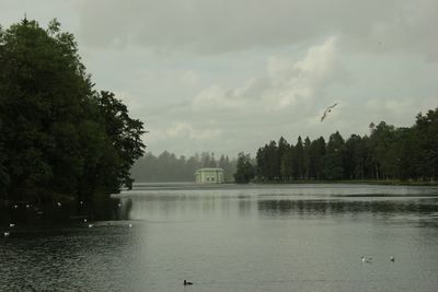 Scenic view of lake against cloudy sky