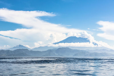 Scenic view of sea and mountains against sky