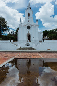 Church by sea against sky