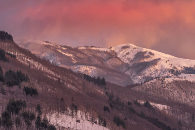 Up and down over the apennines after a big snow blizzard. lovely sunset color clouds over the peaks