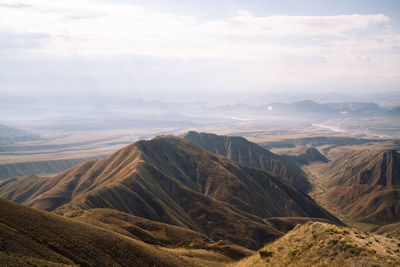 Scenic view of mountains against cloudy sky