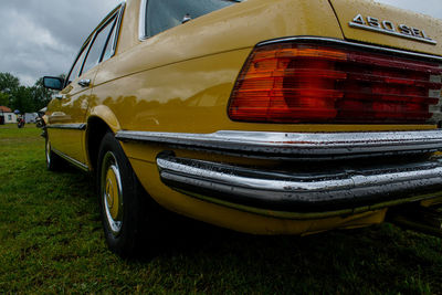 Close-up of yellow car against sky