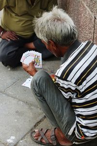 High angle view of men playing cards outdoors