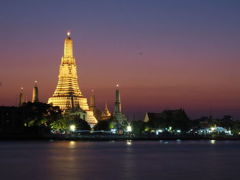 Illuminated temple against sky at night