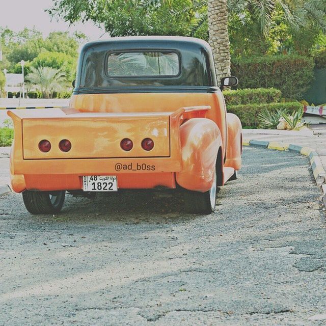 transportation, land vehicle, mode of transport, car, tree, stationary, yellow, street, travel, outdoors, railroad track, old-fashioned, day, road, public transportation, no people, parking, old, rail transportation, vintage car