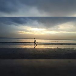 Silhouette of people on beach at sunset