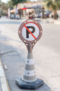 Cone warning about a parking ban of automobile and cars. traffic safety sign on city street road