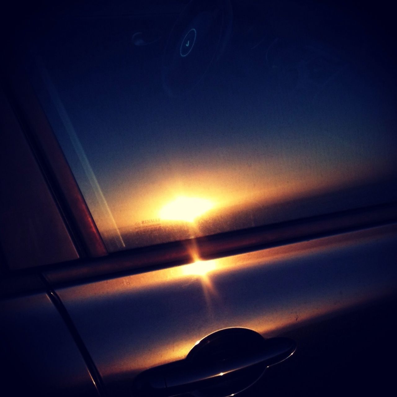 window, transportation, indoors, glass - material, mode of transport, transparent, sunset, vehicle interior, car, orange color, illuminated, dark, no people, land vehicle, reflection, sunlight, glowing, close-up, backgrounds, sun