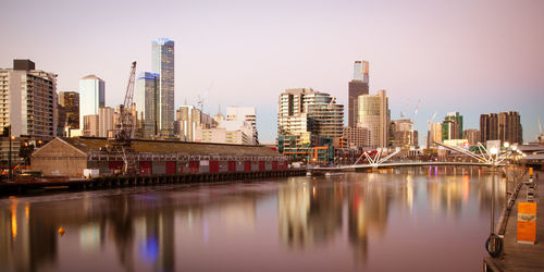 River by buildings against sky in city