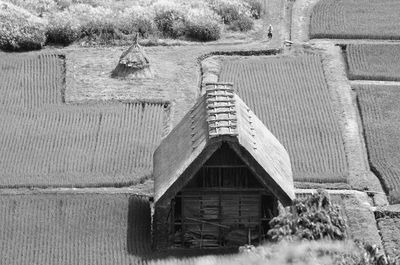 Old abandoned house on field