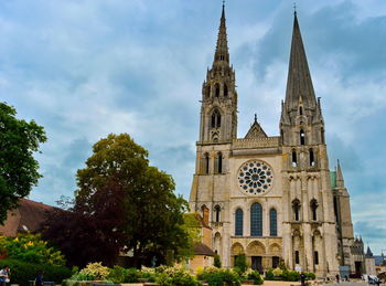 Low angle view of church against cloudy sky