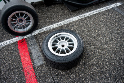 High angle view of tire by racecar on motor racing track