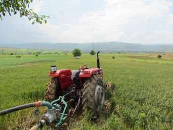 Tractor on field against sky