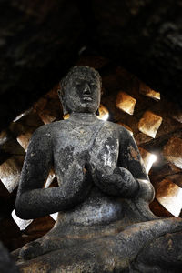 Close-up of buddha statue against temple