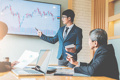 Colleagues working over graph in office