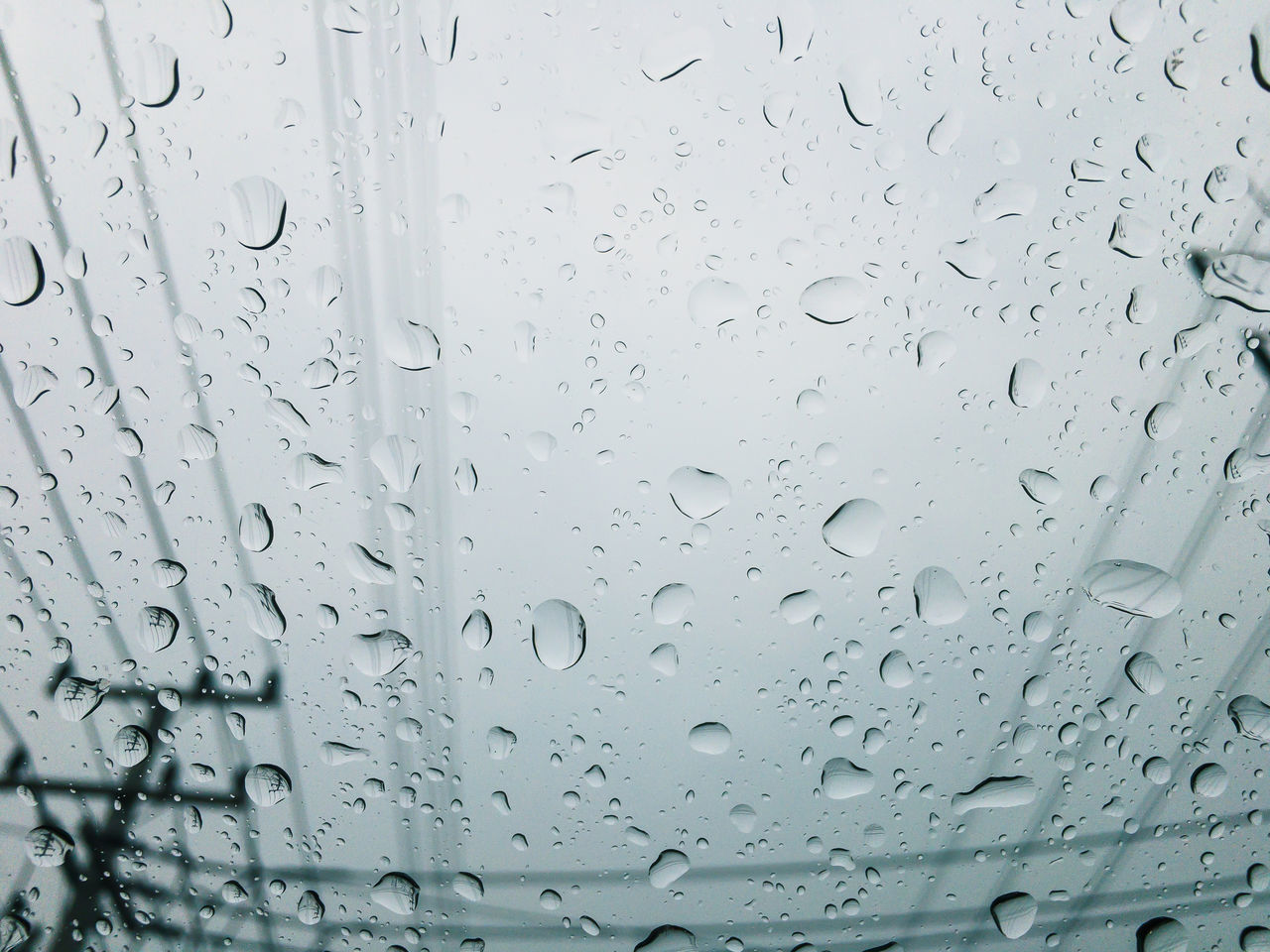 FULL FRAME SHOT OF RAINDROPS ON GLASS WINDOW