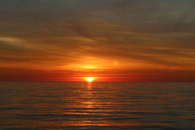Scenic view of sea against romantic sky at sunset