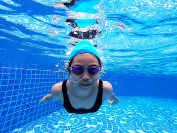 Portrait of girl swimming in pool