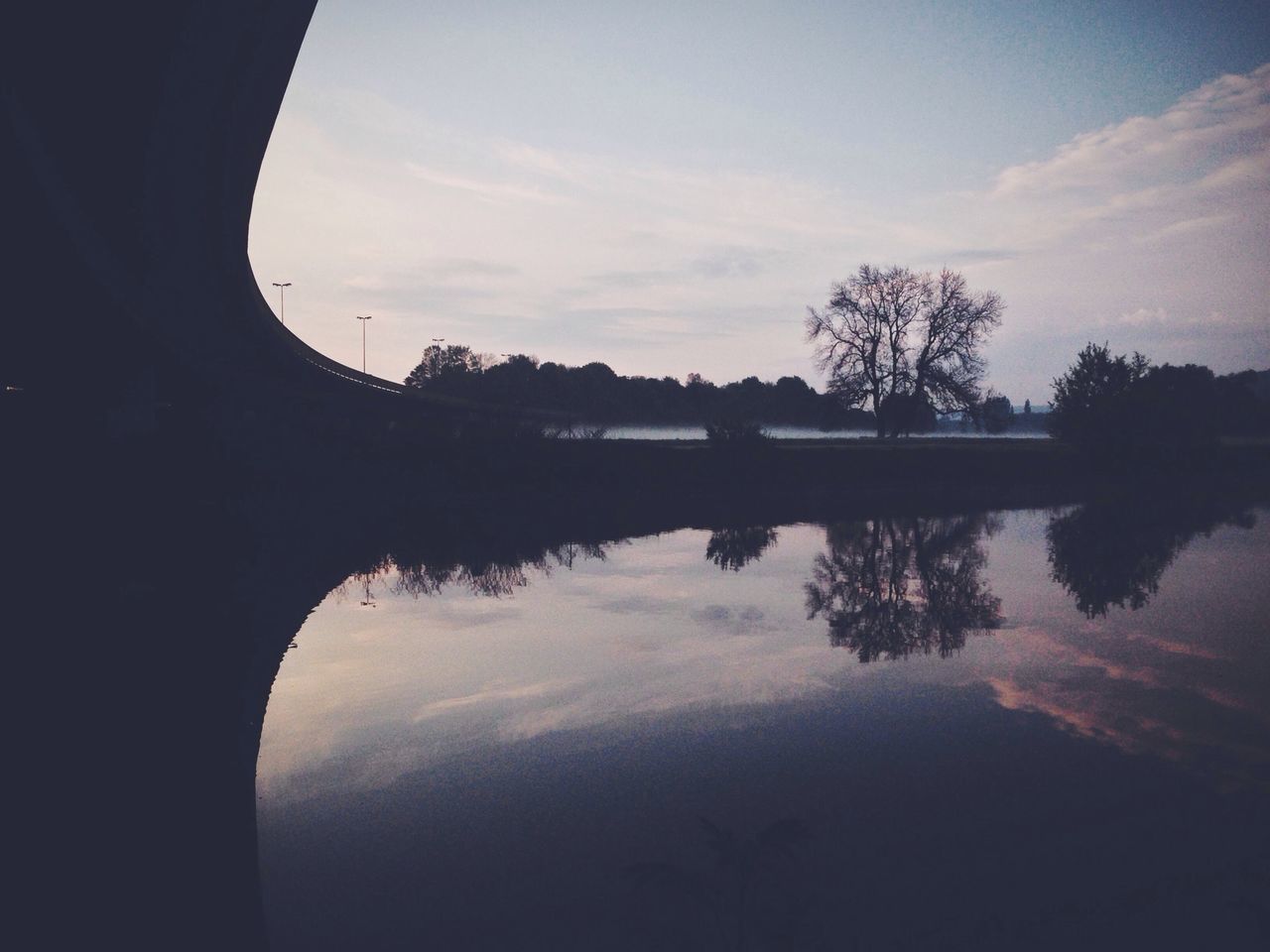 reflection, water, silhouette, sky, tranquility, tranquil scene, tree, lake, sunset, scenics, beauty in nature, cloud - sky, nature, waterfront, standing water, cloud, idyllic, calm, river, dusk