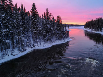 Scenic view of frozen lake against sky during sunset