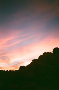 Silhouette landscape against sky during sunset