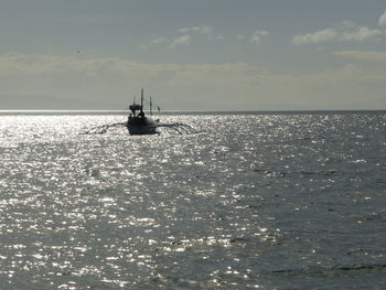 Silhouette of boat sailing in sea