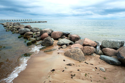 Rocks on beach against sky