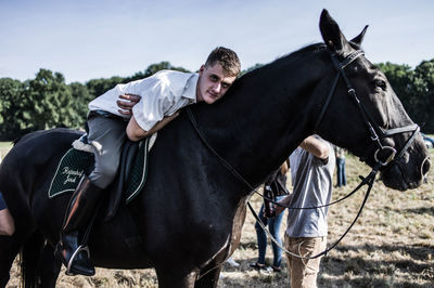 Man riding horse on field