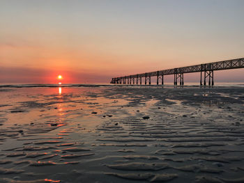 Scenic view of sea against orange sky