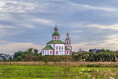 View of building on field against cloudy sky