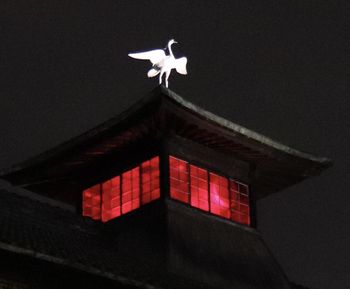 Low angle view of bird flying against sky