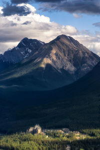 Scenic view of small town and mountains against sky