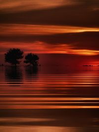 Scenic view of lake against romantic sky at sunset