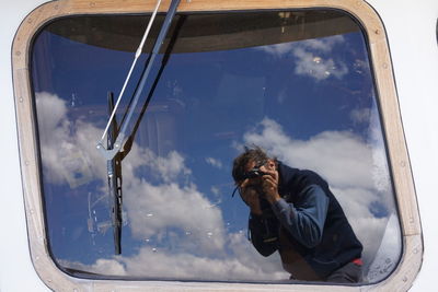 Reflection of man on car window