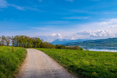 Empty road along countryside landscape