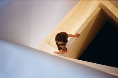 Directly above shot of woman standing on steps in building