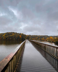 Bridge over lake against sky during autumn