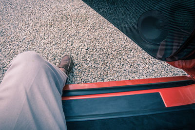 Low section of man stepping off the car