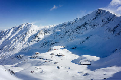 Scenic view of snow covered mountains against sky