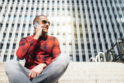 Full length of young man sitting in office building