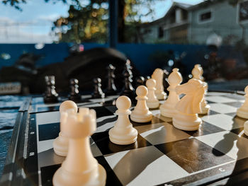 Chess pieces mid game under the sun