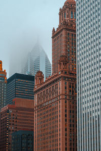 Skyscrapers in city against sky